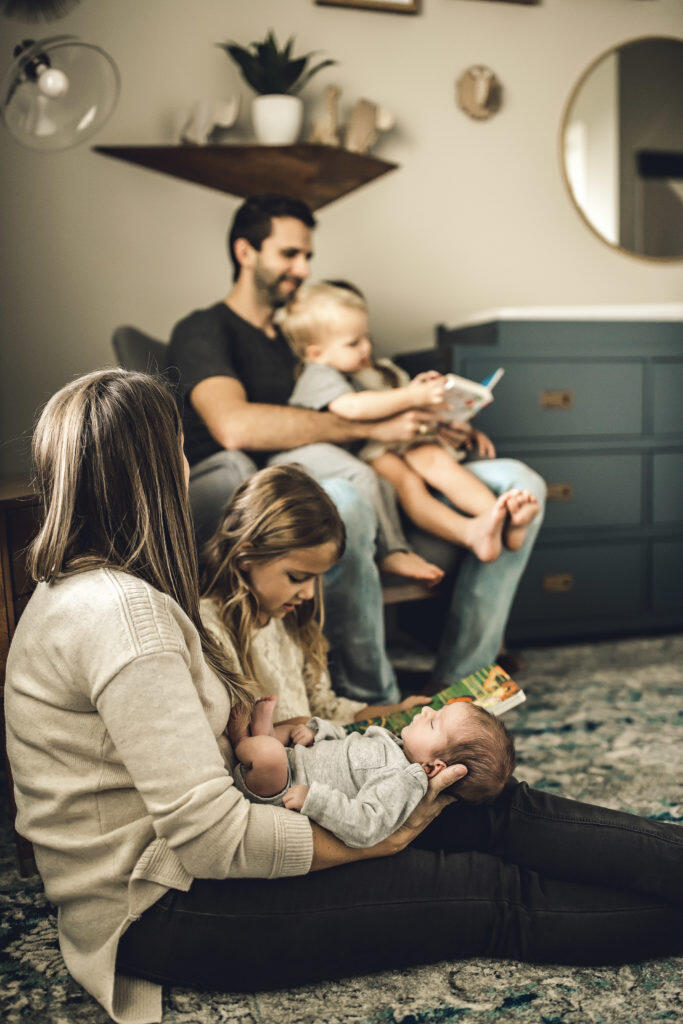 Family of 6 reading books in nursery