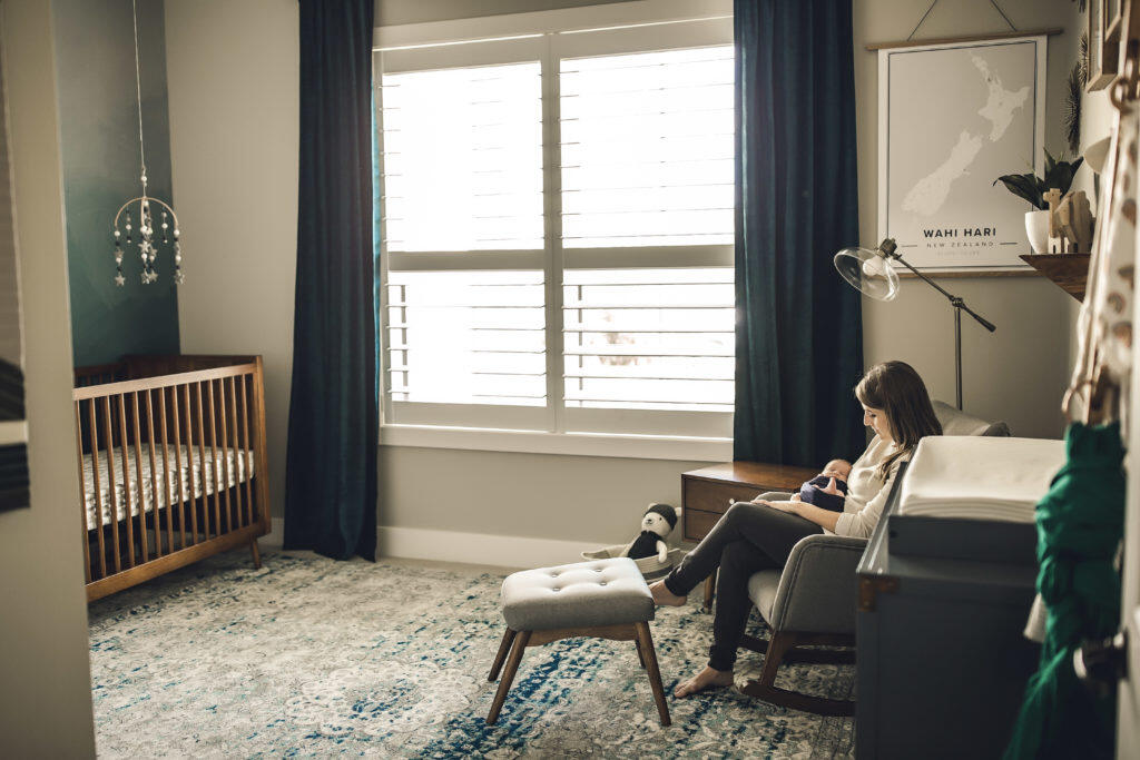 mom and baby amidst navy blue calm and warm hues of mid-century modern nursery